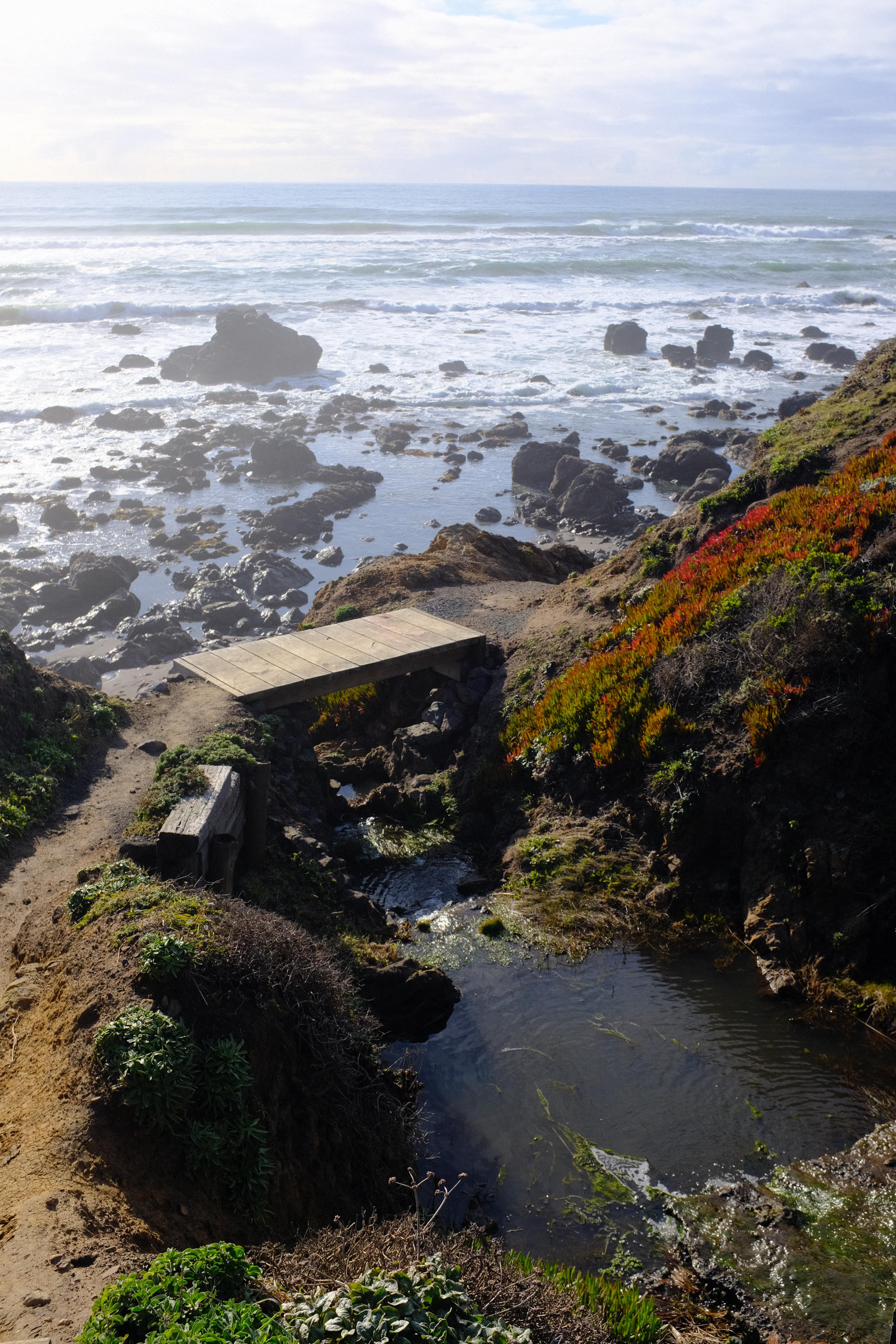 wooden bridge overlooking pacific ocean